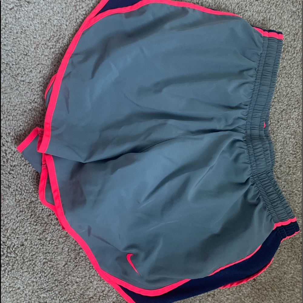 Grey Nike athletic shorts with hot pink and navy details